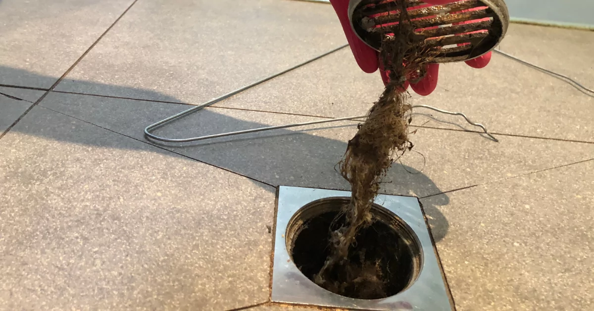 Water backing up out of a floor drain in a home — a clear sign of a main sewer line blockage